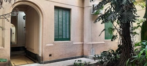 A building with a beige facade, green shutters, and a small entrance. - Charming Historic 1BR Loft w/AC  Sleeps 3 Walk to Obelisco, Congress & San Telmo (Buenos aires)