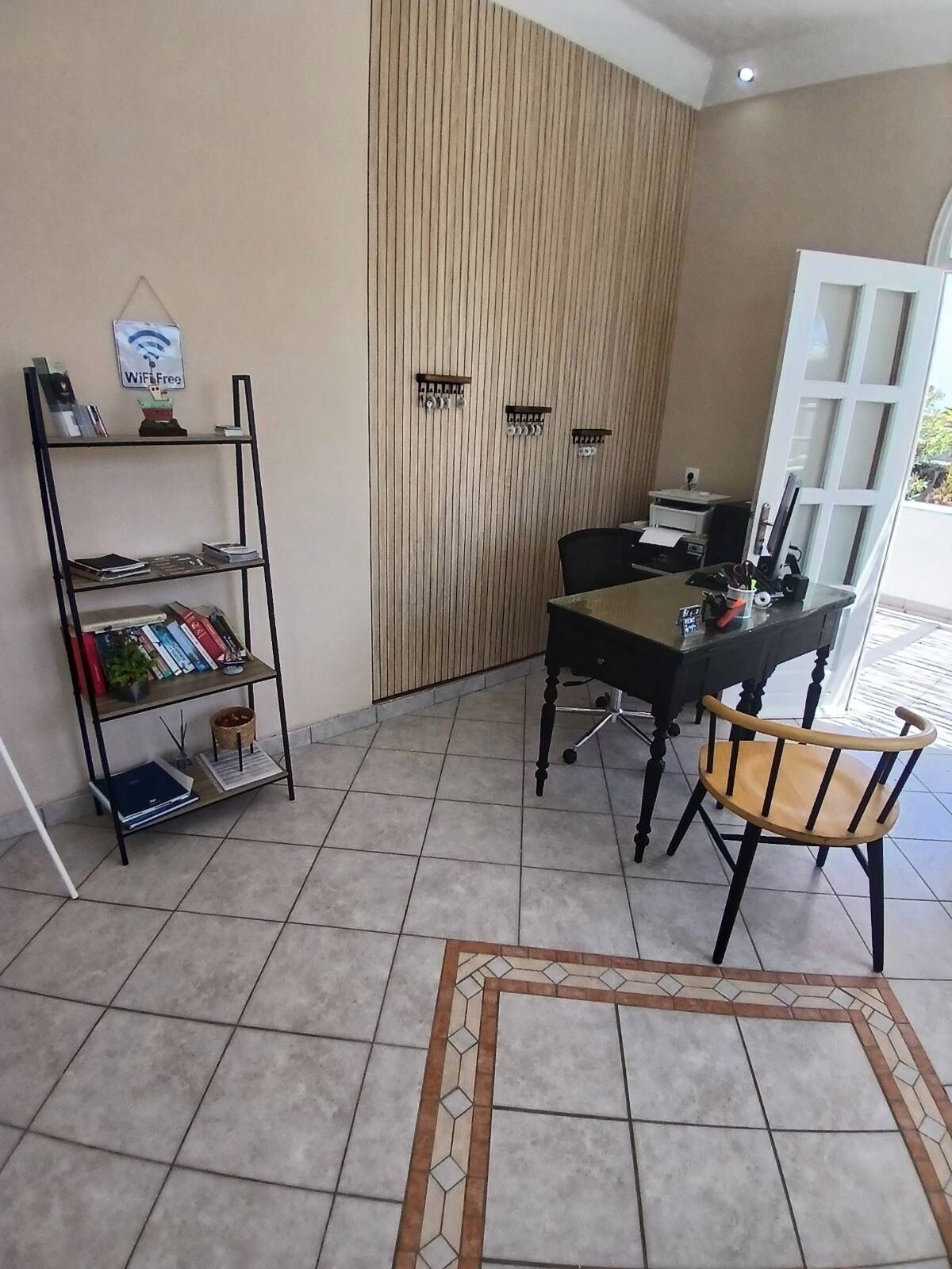 A room with a desk, chair, bookshelf, and a WiFi sign.