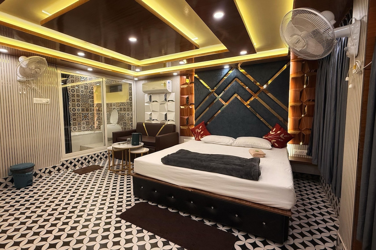 A modern bedroom with a bed, bedside table, and a mirror.
