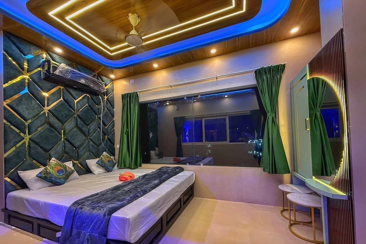 A modern bedroom with a bed, a large window, and a mirror.