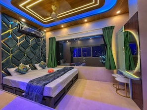 A modern bedroom with a bed, a large window, and a mirror. - Hotel aj plaza (Mayapur)