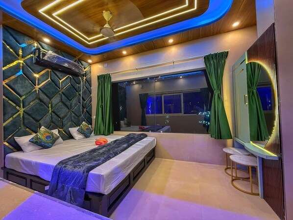 A modern bedroom with a bed, a large window, and a mirror.