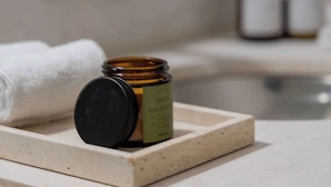 A bathroom with a marble countertop, a bottle of green liquid soap, and a white towel. - A Stone Studio Beside Chapultepec (Ciudad de México)