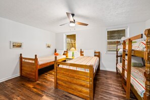 A room with two wooden beds, a ceiling fan, and a window with blinds. - Poolside Paradise: Lakefront; Private Pool; Dock (LaFollette)