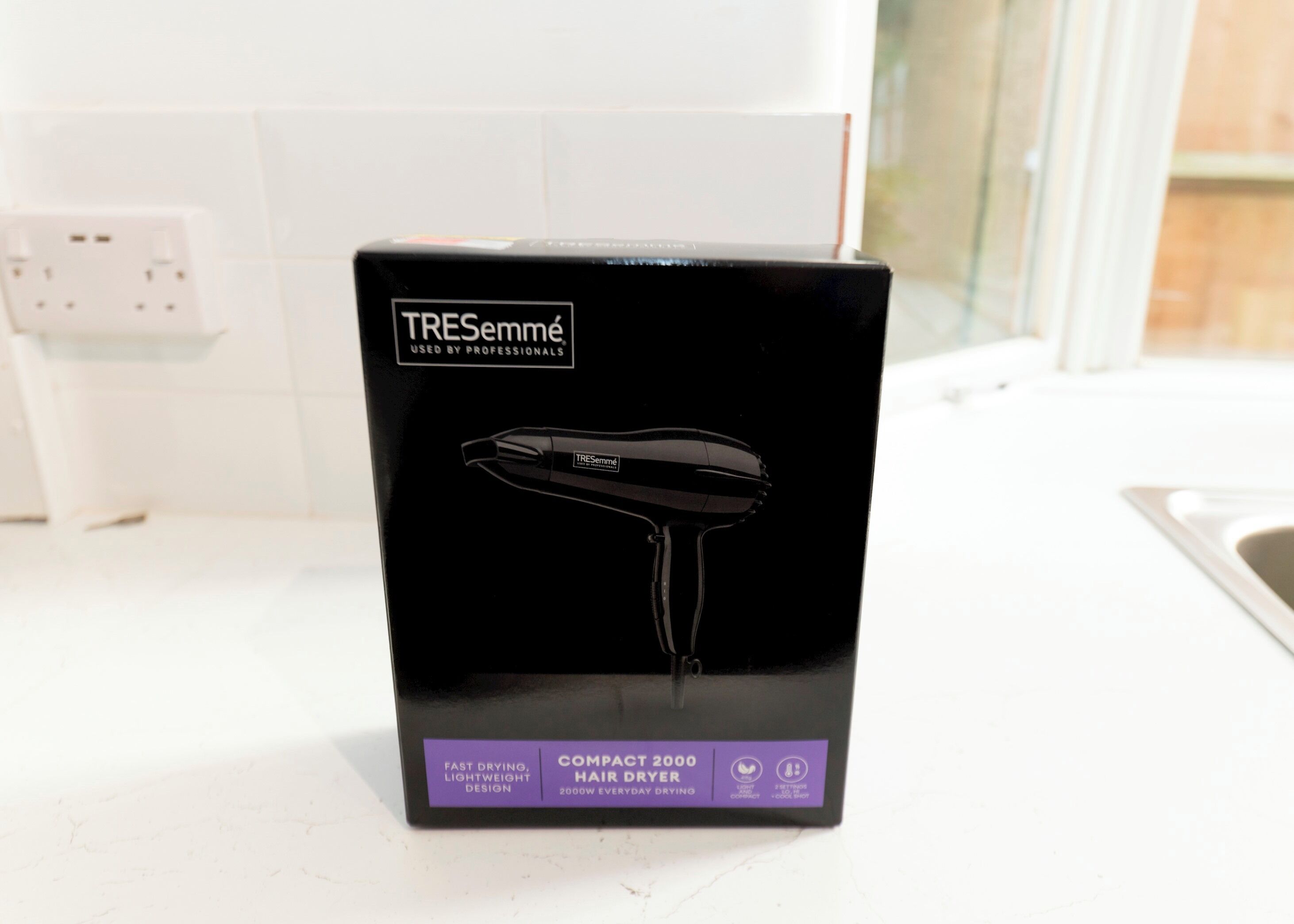 A black box with a hair dryer on it.