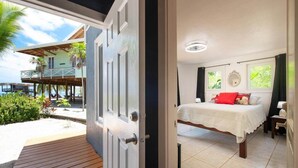 A room with a bed, a nightstand, and a window with curtains. - Milton 2 Br Quiet Beachfront Pool Dock (José Santos Guardiola)
