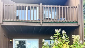 A two-story building with a balcony, windows, and a door. - Studio 6 Lake George, NY - Adirondacks (Lake George)