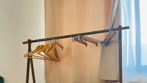 A room with a wooden bed frame, a white mattress, and a wooden bench at the foot of the bed. - Cocoa department, unbeatable location. (puerto escondido)