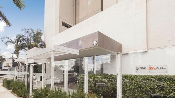 A modern building with a covered entrance, numbered 45, and a sign for 'Prumus SA' indicating a business presence. - Condominium W/pool in a Prime Location in Jardim Goias - Wsls (Goiânia)