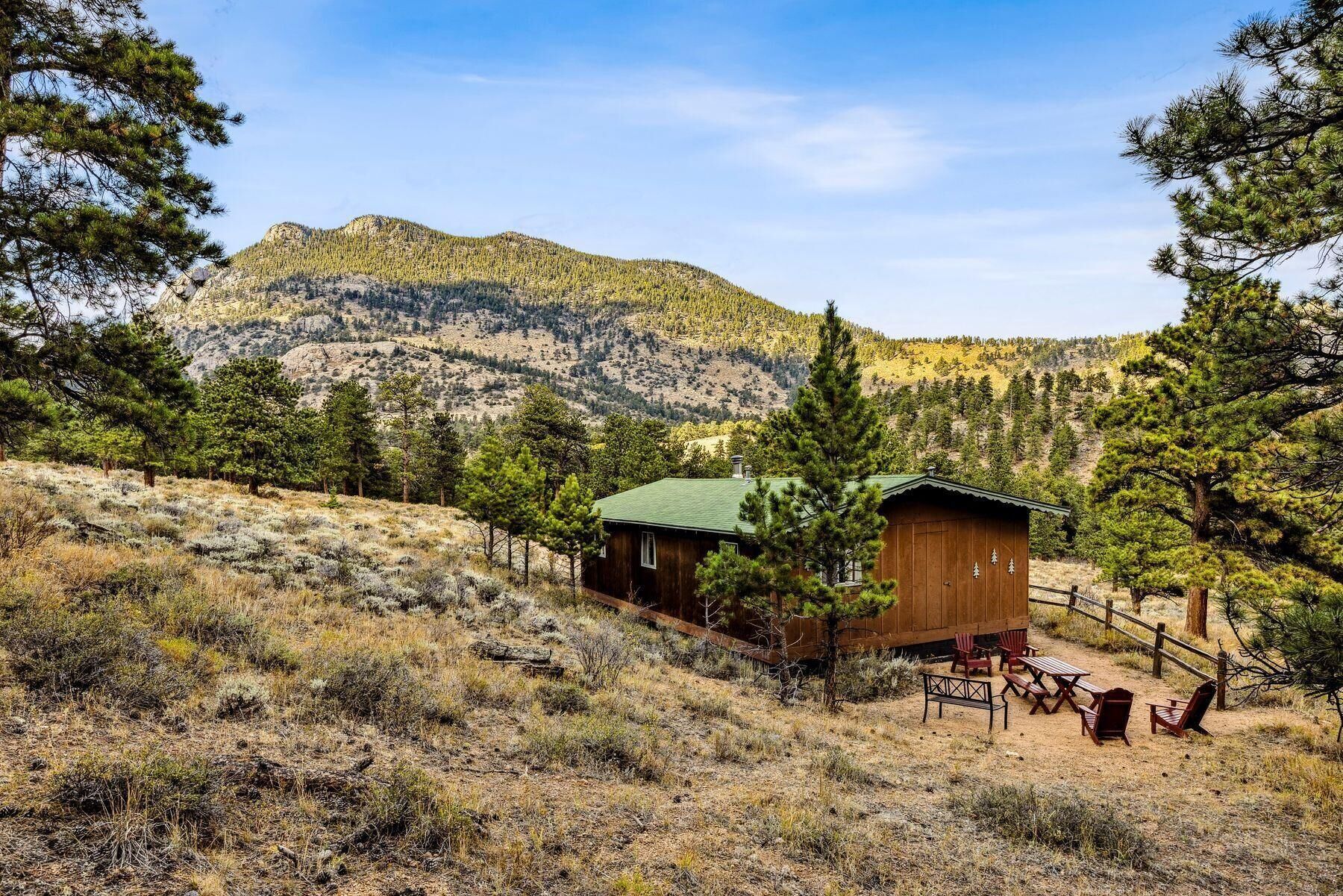 Cabin retreat surrounded by towering pines and mountain views