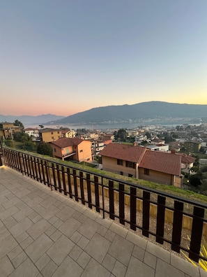 A residential area with houses, a clear sky, and distant mountains.