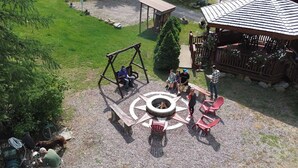 A playground with a swing set, a circular seating area, and a covered pavilion. - Lodge Room with Views of Glacier NP (Hungry Horse)