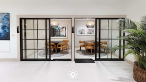 A hotel lobby with a traditional Japanese-style entrance, a reception desk, and a large potted plant. - City Vibes with Spa & Gym in Sleek 1BR Retreat (Miami)