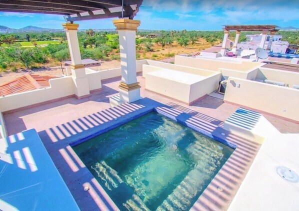 A rooftop pool area with clear blue water, white pillars, and a view of the surrounding landscape. - Luxury 3BR Bloom Villa w/ Pool, Terrace & Golf Views in Cabo San Lucas (Cabo San Lucas)