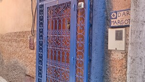 A blue metal gate with intricate designs, a small hanging ornament, and a street sign reading "4 DAR MARGOT". - DAR MARGOT MARRAKECH (Marrakesh)