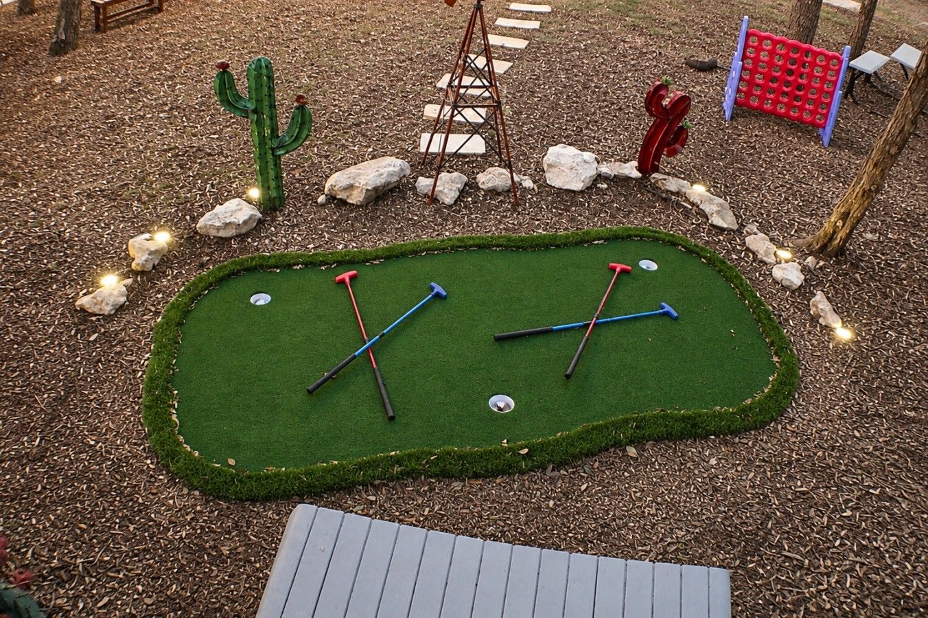 Un parcours de mini-golf doté d’un green, de deux trous et d’un aménagement paysager environnant.