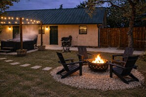 A backyard with a fire pit, outdoor seating, and a barbecue grill. - Canyon Lake Retreat | Hot Tub + Arcade + Mini Golf | Sleeps 8 | Near Boat Ramp (Canyon Lake)