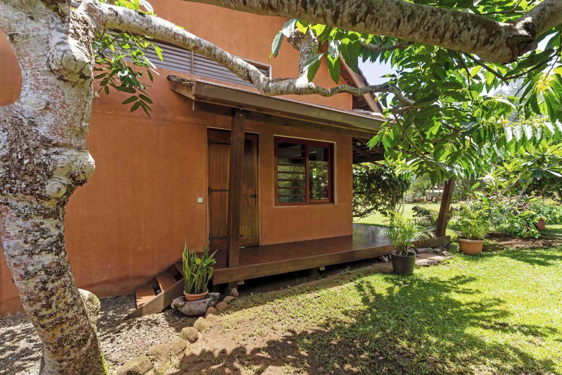 A rustic house with a wooden door, a window, and a small porch.