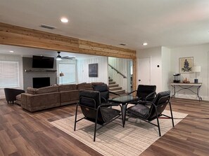 A living room with a sofa, chairs, a coffee table, and a fireplace. - Pecan Grove | Spacious South Abilene Stay (Abilene)