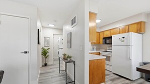 A modern kitchen with wooden cabinets, a white refrigerator, and a microwave. - UO•Downtown(.5 mile)•West University•GuestFavorite (Eugene)