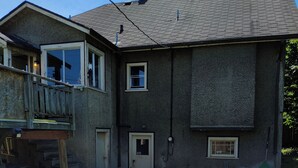 A two-story house with a front porch, a small front yard, and a chimney. - East Vancouver Bachelor Basement Suite. Pet Friendly - No Fee. Next to Transit. (Vancouver)