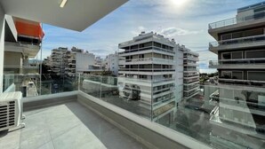 A modern building with multiple balconies, large windows, and a clear sky. - Athenean Modern Escape near Marina Flisvos-E1 (Paleo Faliro)