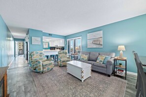 A living room with a sofa, armchairs, a coffee table, and a lamp. - Island Sunrise 169 | Gulf Views| Pool | Low-Density | My Beach Getaways (Gulf Shores)