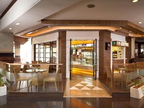 A modern interior with a glass storefront, seating areas, and a visible cafe. - The Heritage Grand Khon Kaen Hotel and Convention (Khon Kaen)
