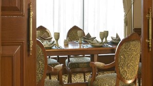 A dining room with a wooden table set for four, surrounded by upholstered chairs with a patterned fabric. - The Heritage Grand Khon Kaen Hotel and Convention (Khon Kaen)