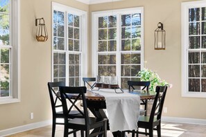 A dining area with a table, chairs, and large windows. - 4 Alabanza Retreat! Hot Spring Village near 4 Golf Courses (Hot Springs Village)