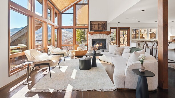 A spacious living room with a fireplace, large windows, and a cozy seating area. - Snowmass Village Retreat, Pet-Friendly, Hot Tub, Game Room & Rooftop Deck Near Base Village (Snowmass Village)