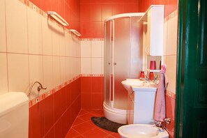 A bathroom with a shower, toilet, sink, and a towel rack. - Authentic Slavonian home with pool, barbecue and orchard (Lug)