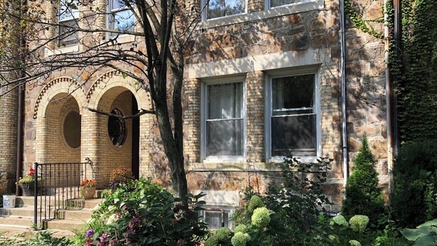 A stone building with arched windows and a brick facade. - Family friendly neighborhood spacious 3-bedrooms, 2 baths,  parking, near train. (Brookline)
