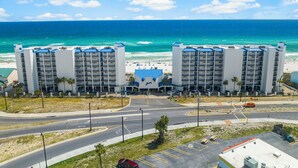 A beachfront hotel with two buildings, a parking lot, and a road leading to the beach. - New Listing!   Fall Specials & Free Beach Chair Service ~ 3rd Floor (Panama City Beach)