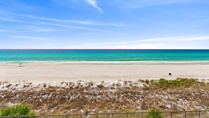 A beach with a fence in the foreground and a clear sky. - New Listing!   Fall Specials & Free Beach Chair Service ~ 3rd Floor (Panama City Beach)