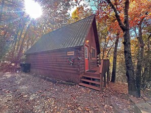 A wooden cabin with a red door, a small porch, and a sign labeled 'Hideaway.' - Hideaway Cabin Bryson City, NC - 5 Minutes from Downtown (Bryson City)
