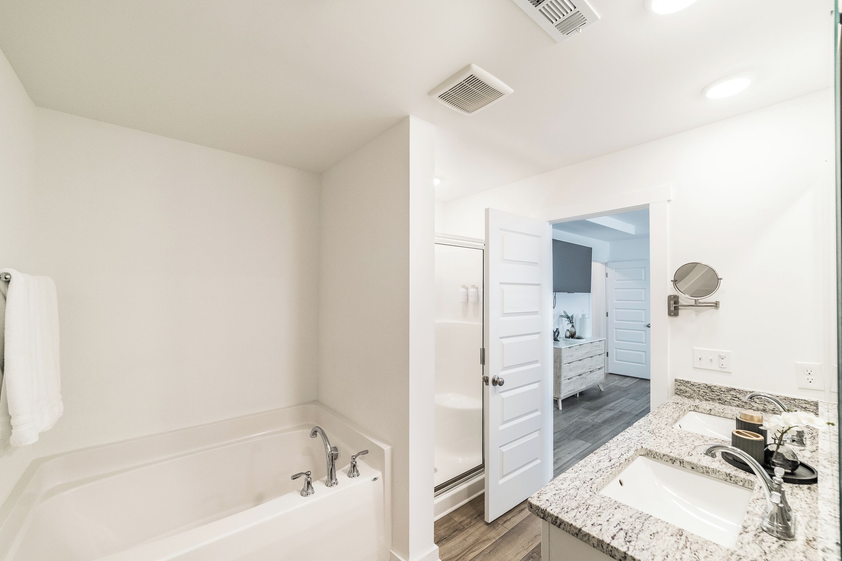 Un baño con bañera, ducha y lavabo con espejo.