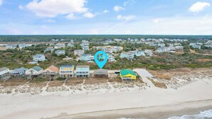 A coastal residential area with beachfront properties, a sandy beach, and ocean waves. - "Charisma"  4 Bedroom, 2 Bathroom, Oceanfront (Holden Beach)