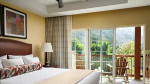 A hotel room with a large bed, a nightstand, a lamp, a chair, and a balcony with a view of greenery. - Resorts among beautiful mountains in Escondido, CA with 2 beds,full kitchen (Escondido)