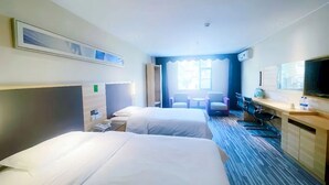 A hotel room with two beds, a desk, a chair, a TV, and a window. - City Comfort Inn GZ Baiyundadaobei (Guangzhou)