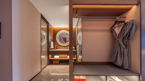 A modern bathroom with a vanity, mirror, and robe rack. - UrCove by Hyatt Taicang South Railway (Suzhou)
