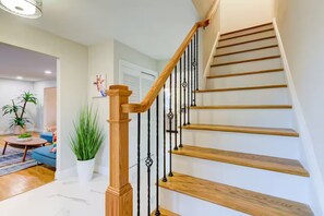 A staircase with wooden steps and black metal railings, leading to an upper floor. - Sunset Point 4 Bedroom Home by D&R canal (Princeton)