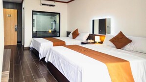 A hotel room with two beds, a large mirror, a bedside lamp, and an air conditioning unit. - Tien Thanh Hotel (Hung Nguyen)