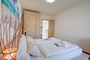 A hotel room with a bed, a wardrobe, and a painting on the wall. - Agritur Laura- Oasi di luce 5 with Shared Garden, Torbole sul Garda, Italy (Torbole sul Garda)