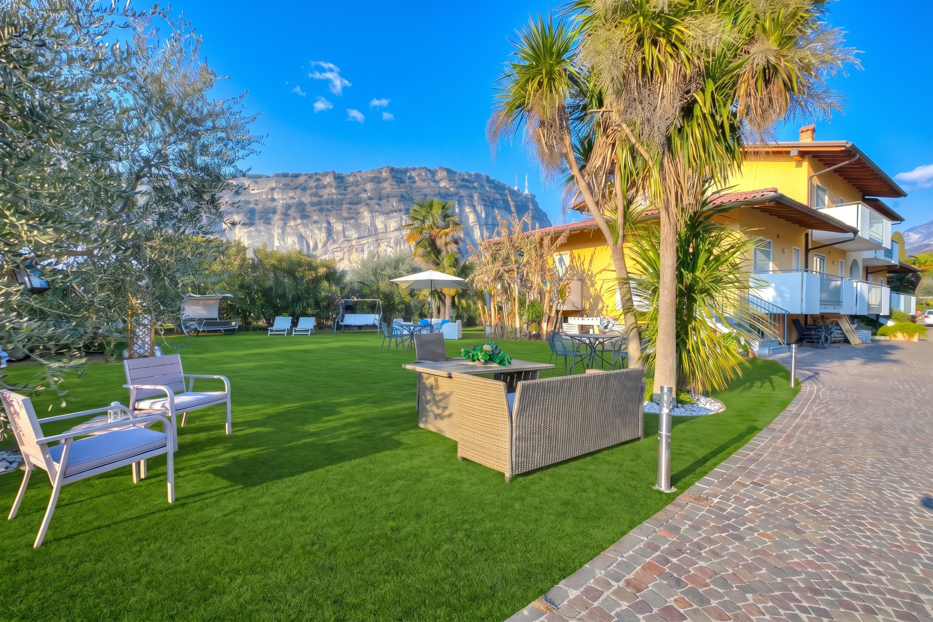 A well-maintained outdoor area with a patio, seating, and a view of a mountain.