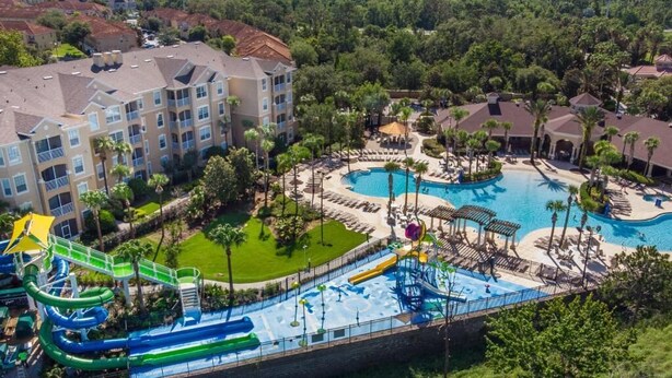 A resort with multiple swimming pools, a water park, and a large building with balconies. - Windsor Hills Resort (Kissimmee)