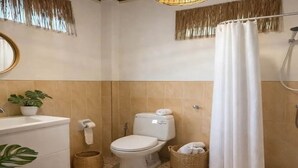 A bathroom with a toilet, sink, shower, and decorative plants. - Paradise in Koh Phangan with Fast Internet (Ko Pha-ngan)