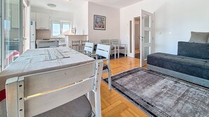 A modern apartment with a dining area, kitchen, and living room. - Apartment Rilić by Interhome (Zaostrog)