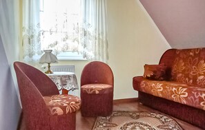 A room with a sofa, two armchairs, a small table with a lamp, and a patterned rug. - 3 bedroom pet friendly home in Jezierzany (Jezierzany)
