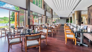 A spacious dining area with long tables and chairs, large windows, and a modern ceiling design. - Baiyun Lakeside Hotel (Guangzhou)